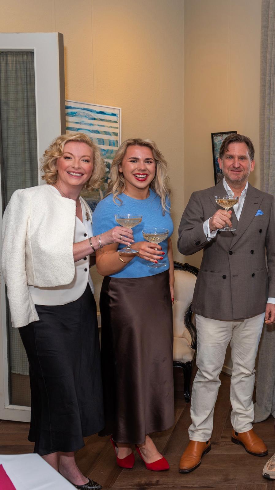Three guests raising champagne coupes at Dutch Masters Studio