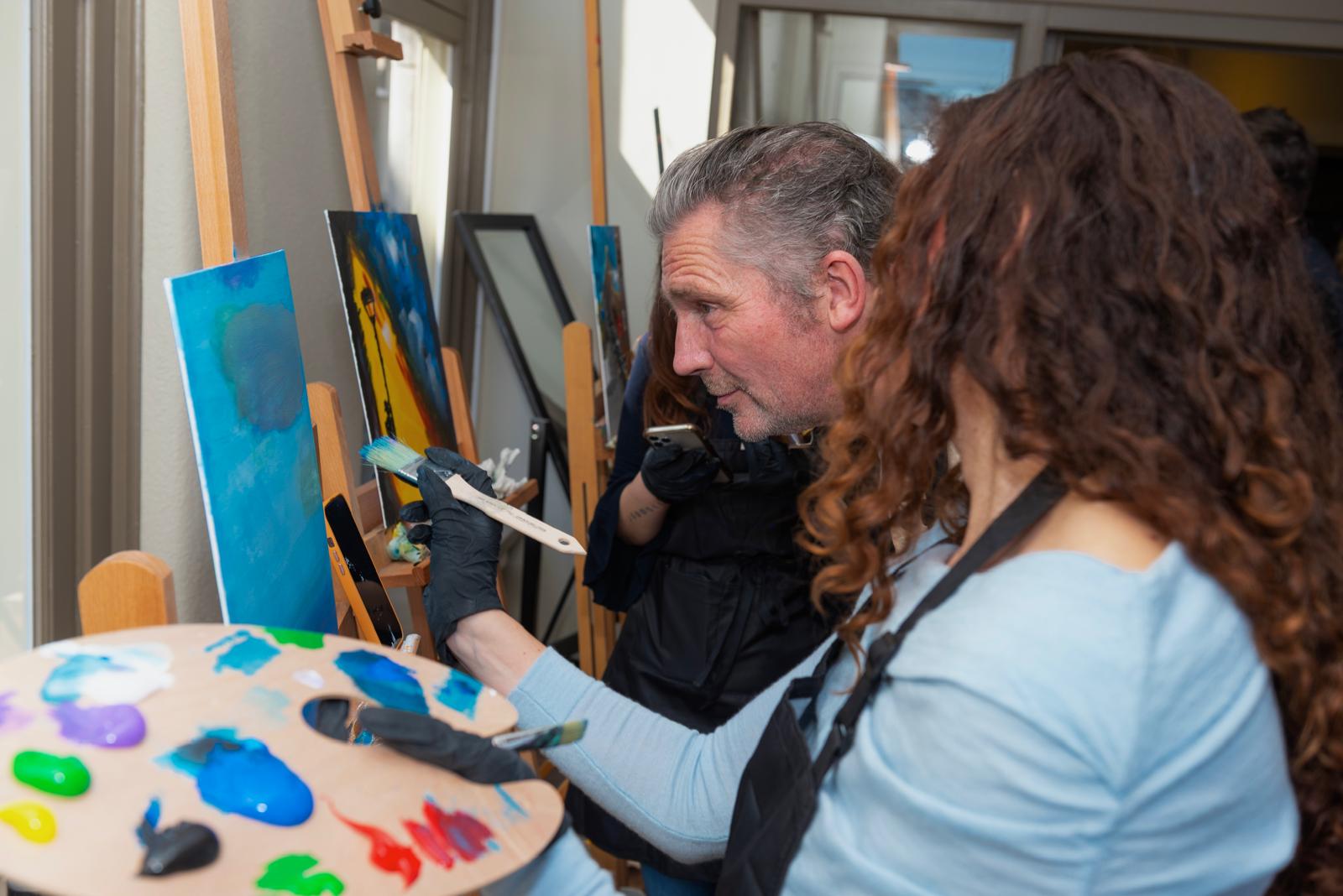 Guests painting up close with palette and brush at Dutch Masters Studio